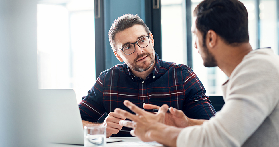 Two men having a conversation in an office