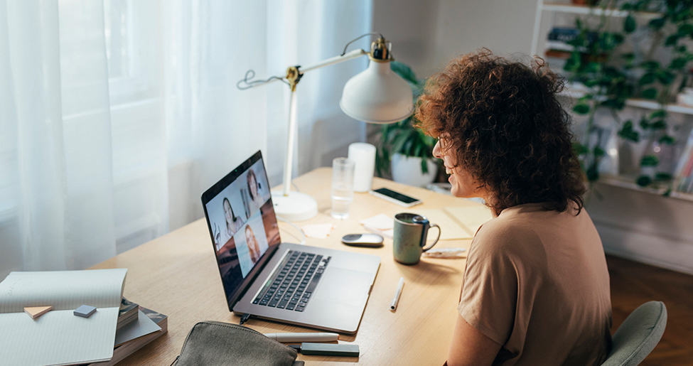 woman sitting at laptop on video call